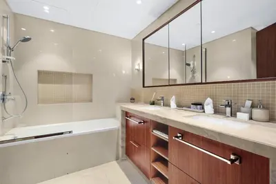 a bathroom with two sinks and a tub and a shower at Skyline Views 2BR Near Burj Khalifa & Dubai Mall with Pool Access in Dubai