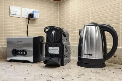 a kitchen counter with a coffee maker and a toaster at Skyline Views 2BR Near Burj Khalifa & Dubai Mall with Pool Access in Dubai