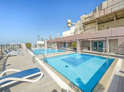 a large swimming pool on top of a building at 2BR Family Apt with Pool, Gym and Jumeirah Lake Views in Dubai