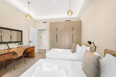a bedroom with a desk and a bed and a desk at 2BR Family Apt with Pool, Gym and Jumeirah Lake Views in Dubai