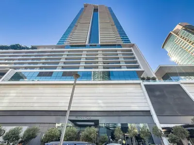 a tall building with a car parked in front of it at FIRST CLASS Dubai Marina 2BR with City Views, Balcony, Pool, Gym & Parking in Dubai