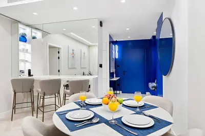 a dining room with a table with glasses of orange juice at FIRST CLASS Dubai Marina 2BR with City Views, Balcony, Pool, Gym & Parking in Dubai