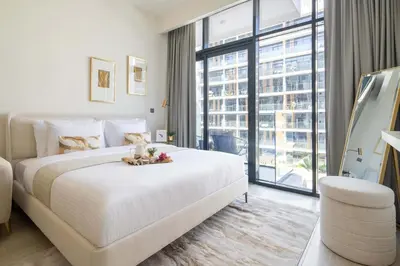 a white bedroom with a large bed and a large window at Frank Porter - Azizi Riviera 28 in Dubai