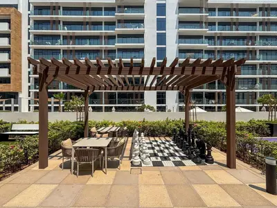 a chess board and tables and chairs with a chessboard and a chess board at Frank Porter - Azizi Riviera 28 in Dubai