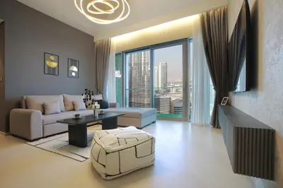 a living room with a couch and a large window at Burj Khalifa & Fountain Views, Pool, Free Parking in Dubai