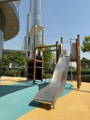 a playground with a slide in a park at Burj Khalifa & Fountain Views, Pool, Free Parking in Dubai