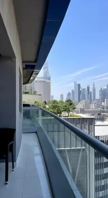 a balcony of a building with a view of a city at Downtown Dubai - Damac Maison Mall Street in Dubai