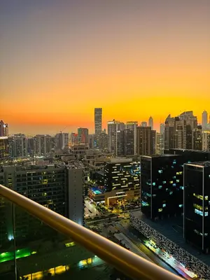 a view of a city skyline at sunset at Modern Apartment in Downtown Dubai in Dubai