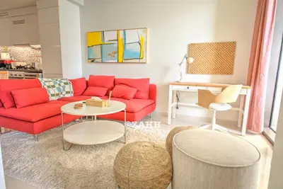 a living room with a red couch and a table at Business bay Chic Apartment in Dubai