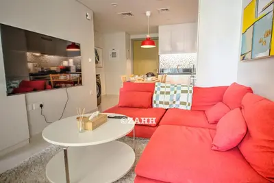 a living room with a red couch and a table at Business bay Chic Apartment in Dubai