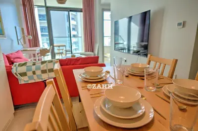 a dining room with a table with dishes on it at Business bay Chic Apartment in Dubai