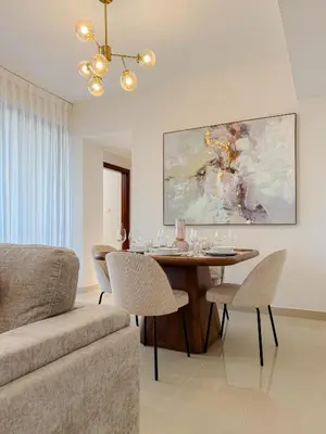 a living room with a table and a couch at Burj Khalifa View Apartment 10 min Walking to Dubai Mall in Dubai