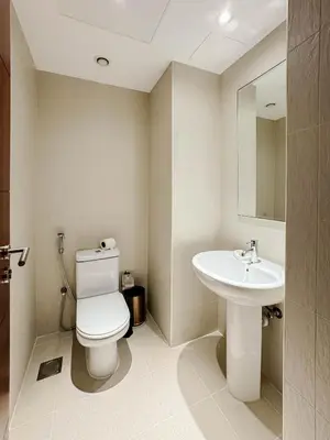 a bathroom with a toilet and a sink at Burj Khalifa View Apartment 10 min Walking to Dubai Mall in Dubai