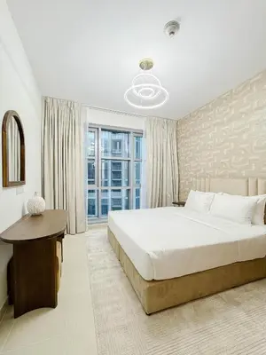 a bedroom with a large bed and a window at Burj Khalifa View Apartment 10 min Walking to Dubai Mall in Dubai