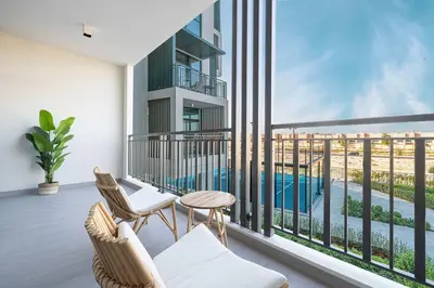 a balcony with two chairs and a table at Legacy by Sunrise - Top Amenities and Paddle Court in Dubai