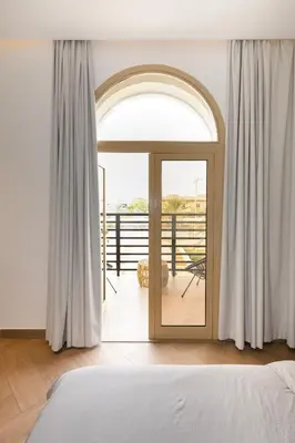 a bedroom with a door leading to a balcony at Luxurious Villa 5BHK with Pool BBQ and Full Time Housemaid Assistance - live in in Dubai