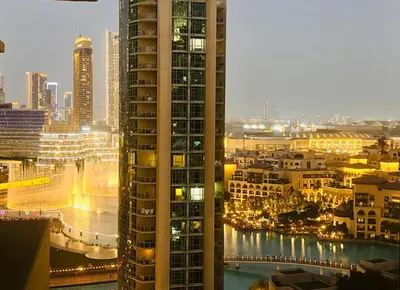 a view of a city at night with buildings at Luxury One Bedroom Apartment with Fountain View opposite Dubai Mall in Dubai
