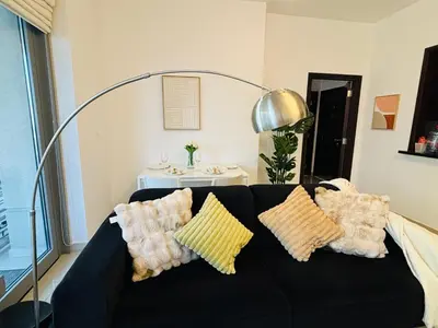 a black couch with pillows on it in a living room at Luxury One Bedroom Apartment with Fountain View opposite Dubai Mall in Dubai