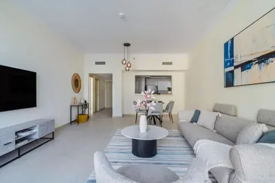 a living room with a couch and a table at Beachy Getaway in JBR with Private Beach Access in Dubai