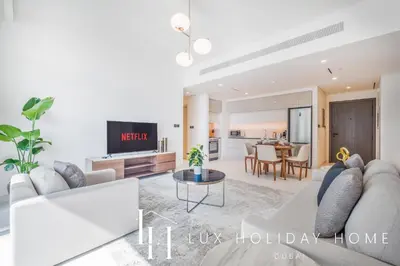 a living room with a couch and a table at LUX The Marina Vista Beachfront Suite 4 in Dubai
