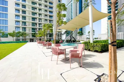 a patio with tables and chairs and a building at LUX The Marina Vista Beachfront Suite 4 in Dubai