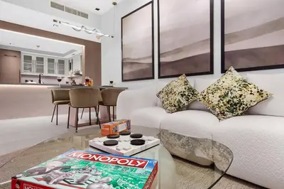 a living room with a white couch and a table at FIRST CLASS 1BR Breathtaking Downtown View in Dubai