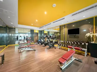 a gym with a bunch of chairs and a tv at 1BR Dubai, Merano Canal View Retreat Near Metro Dining Shopping Mall in Dubai
