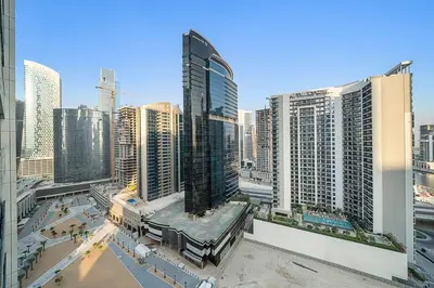a view of a city skyline with tall buildings at 1BR Dubai, Merano Canal View Retreat Near Metro Dining Shopping Mall in Dubai