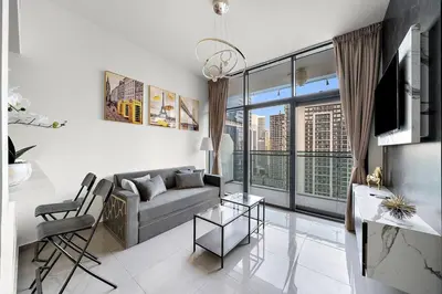 a living room with a couch and a large window at 1BR Dubai, Merano Canal View Retreat Near Metro Dining Shopping Mall in Dubai