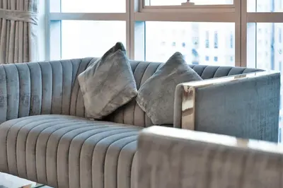 a couch with two pillows on it in a living room at Luxury 2BRin Torch Tower with Dubai Marina Skyline Views in Dubai