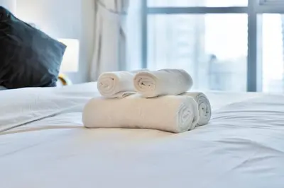 a pile of towels sitting on top of a bed at Luxury 2BRin Torch Tower with Dubai Marina Skyline Views in Dubai