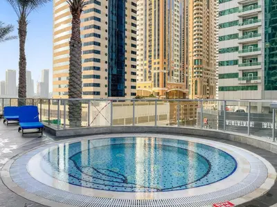 a swimming pool on top of a building with tall buildings at Luxury 2BRin Torch Tower with Dubai Marina Skyline Views in Dubai