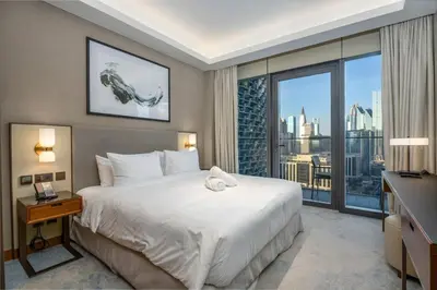 a bedroom with a large bed and a large window at Family 3BR Flat Free Parking, Gym, Pool & Burj Views in Dubai