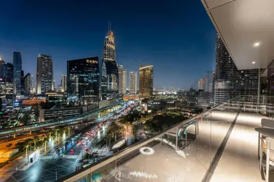 a view of a city skyline at night at Family 3BR Flat Free Parking, Gym, Pool & Burj Views in Dubai