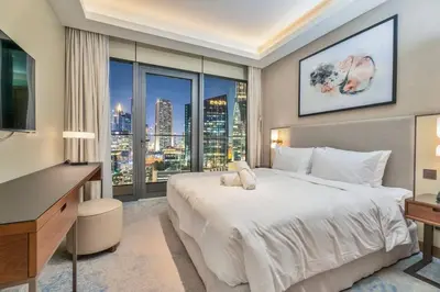 a bedroom with a large bed and a large window at Family 3BR Flat Free Parking, Gym, Pool & Burj Views in Dubai