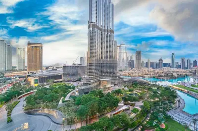 an aerial view of a city with a tall skyscraper at Family 3BR Flat Free Parking, Gym, Pool & Burj Views in Dubai