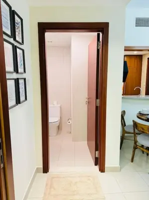 an open door to a bathroom with a toilet at 1 BHK Apartment in Dubai in front of Burj Khalifa in Dubai