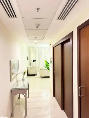 a hallway with a table and a living room at 1 BHK Apartment in Dubai in front of Burj Khalifa in Dubai
