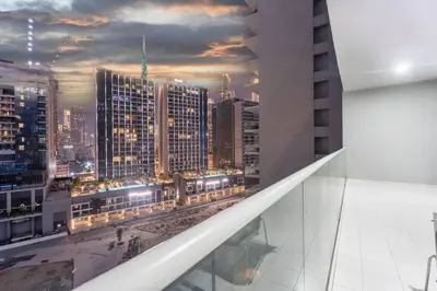 a view of a city at night from a building at FIRST CLASS 2BR Luxury Urban Escape in Dubai