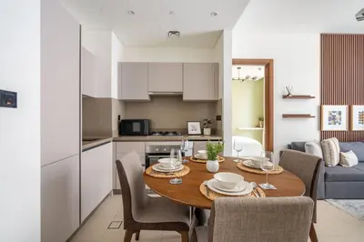 a kitchen and dining room with a table and chairs at GuestReady - Family retreat at Sobha Creek Vista in Dubai