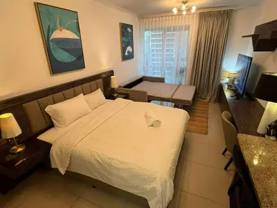 a bedroom with a bed and a table and a desk at Stunning Apartment - High Floor - Canal View in Dubai