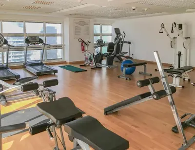 a gym with several treadmills and exercise machines at Stunning Apartment - High Floor - Canal View in Dubai