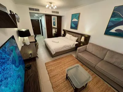 a living room with a bed and a couch at Stunning Apartment - High Floor - Canal View in Dubai