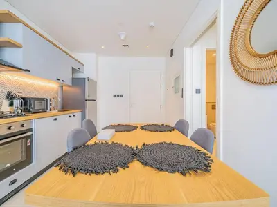 a kitchen with a table with a large rug on it at Dubai Hills estate - 1Bedroom Apt in Dubai