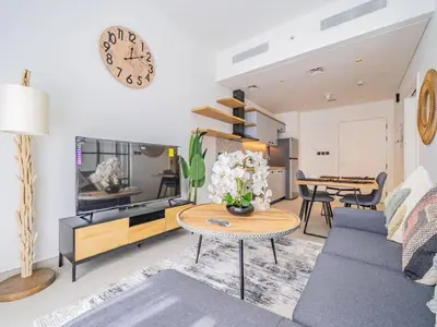 a living room with a couch and a table at Dubai Hills estate - 1Bedroom Apt in Dubai
