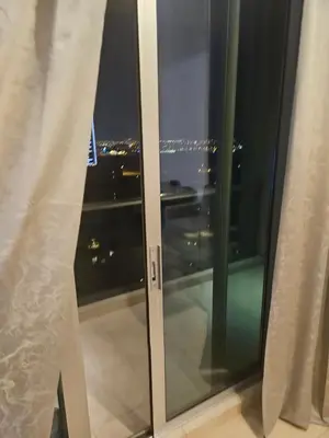 a glass window with a view of the city at Fairways north in Dubai