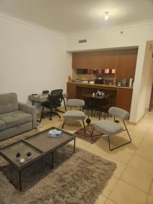 a living room with a couch and chairs and a table at Fairways north in Dubai