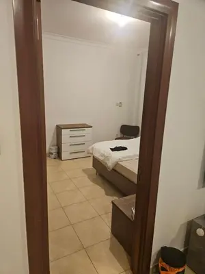 a bedroom with a bed and a mirror at Fairways north in Dubai
