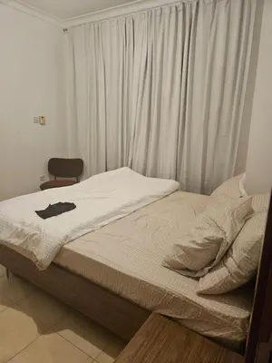 a bed in a bedroom with a white curtain at Fairways north in Dubai
