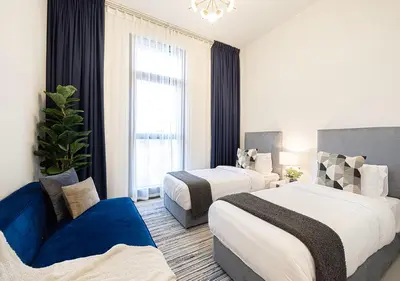 a hotel room with two beds and a blue couch at Lux Escape, Burj Crown Opera View, Near Dubai Mall in Dubai
